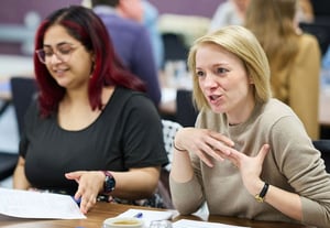 A hybrid team coming together in-person to collaborate using strengths-based leadership for engagement and productivity.