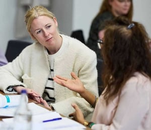 Two attendees deep in discussion at a workshop