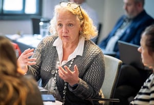 A womon deep in conversations with other attendees at a workshop