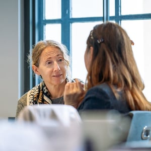 Two women talking to each other at a Discovery workshop
