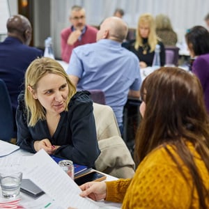 Two women talking to each other at an Appreciative Inquiry workshop