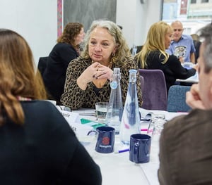 A woman listening intently at an Appreciative Inquiry workshop