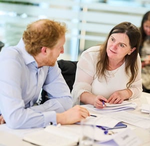 Two health care professionals in discussion at a workshop