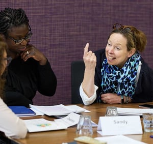 Two local government employees deep in conversation at a workshop