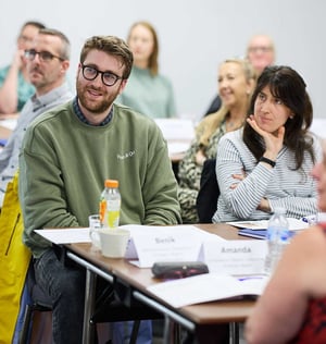 Attendees at a workshop listening to the facilitator