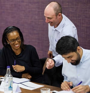 A facilitator talking to attendees at a Management Development Programme