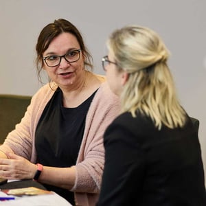 Two women in conversation at a Management Development Programme