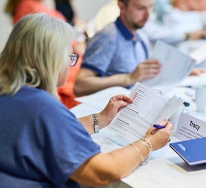 A woman at a workshop reading her Strengthify profile