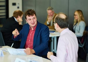 Two men talking together at a Discovery workshop