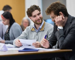 Two men having a conversation at a team workshop