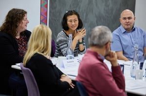 A diverse team in a meeting, engaged in inclusive conversation.