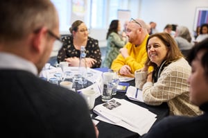 A team engaging in a supportive discussion, fostering open communication and collaboration to combat employee burnout.