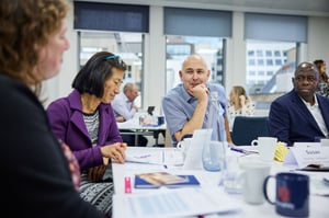 A manager discussing performance strategies with a team member in a collaborative meeting.