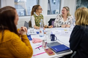 A manager coaches a team member, fostering personal growth through strengths.