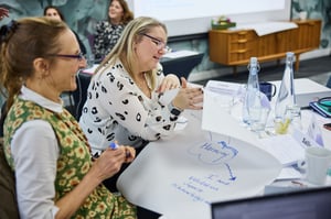 Two members of the University of Plymouth Finance Team smiling and engaged during their team day, reflecting on their strengths and collaboration.