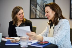 Manager actively listening in a one-to-one conversation, showing openness and attention through posture and body language.