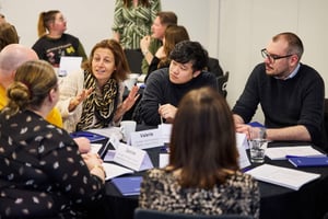 A manager leads a team discussion, highlighting strengths to tackle challenges with confidence.