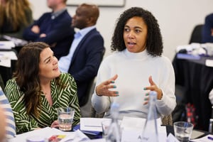 A manager leads a team discussion, fostering unity through strengths-based collaboration.
